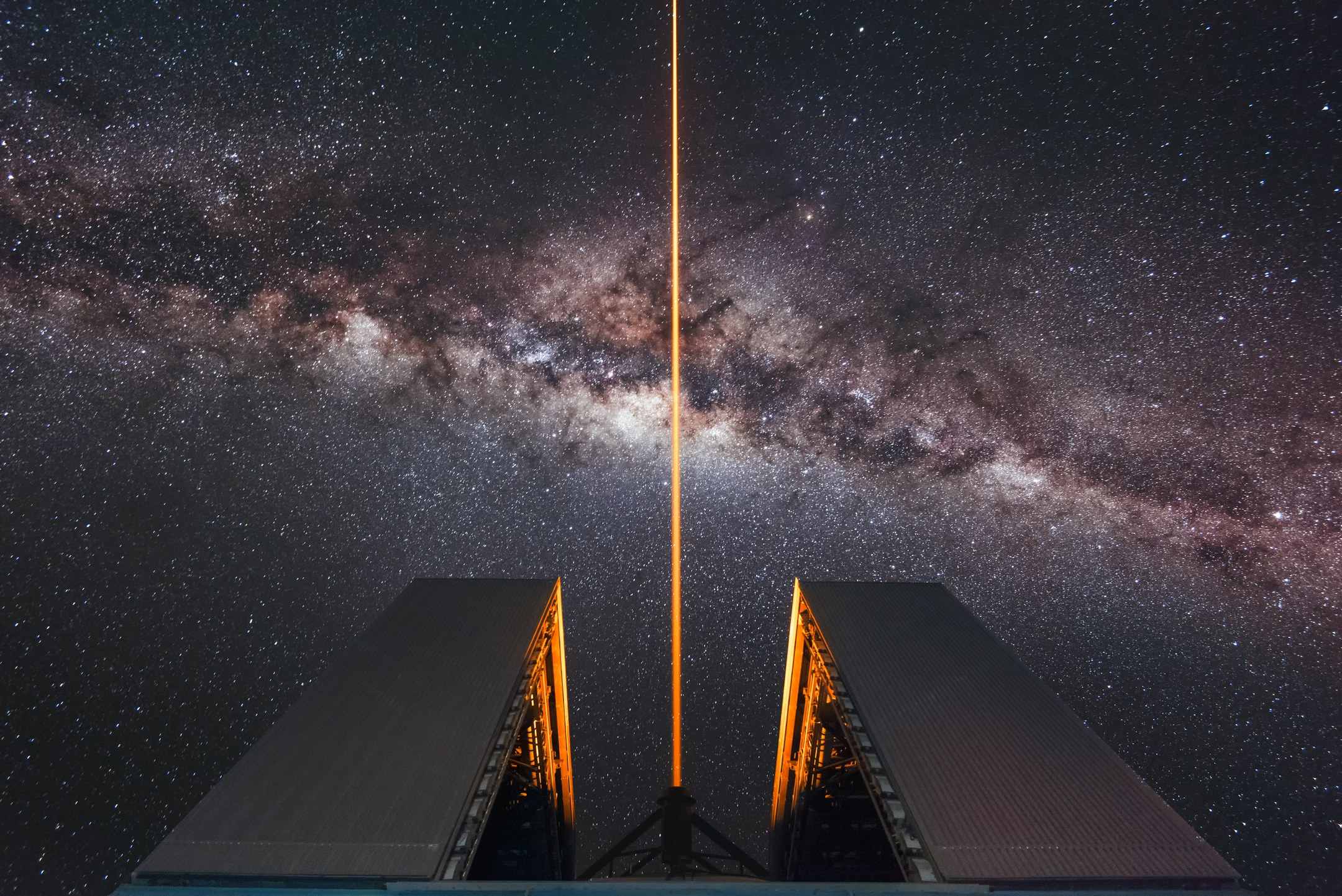A laser guide star beam from ESO’s Very Large Telescope crossing the Milky Way above Paranal Observatory.